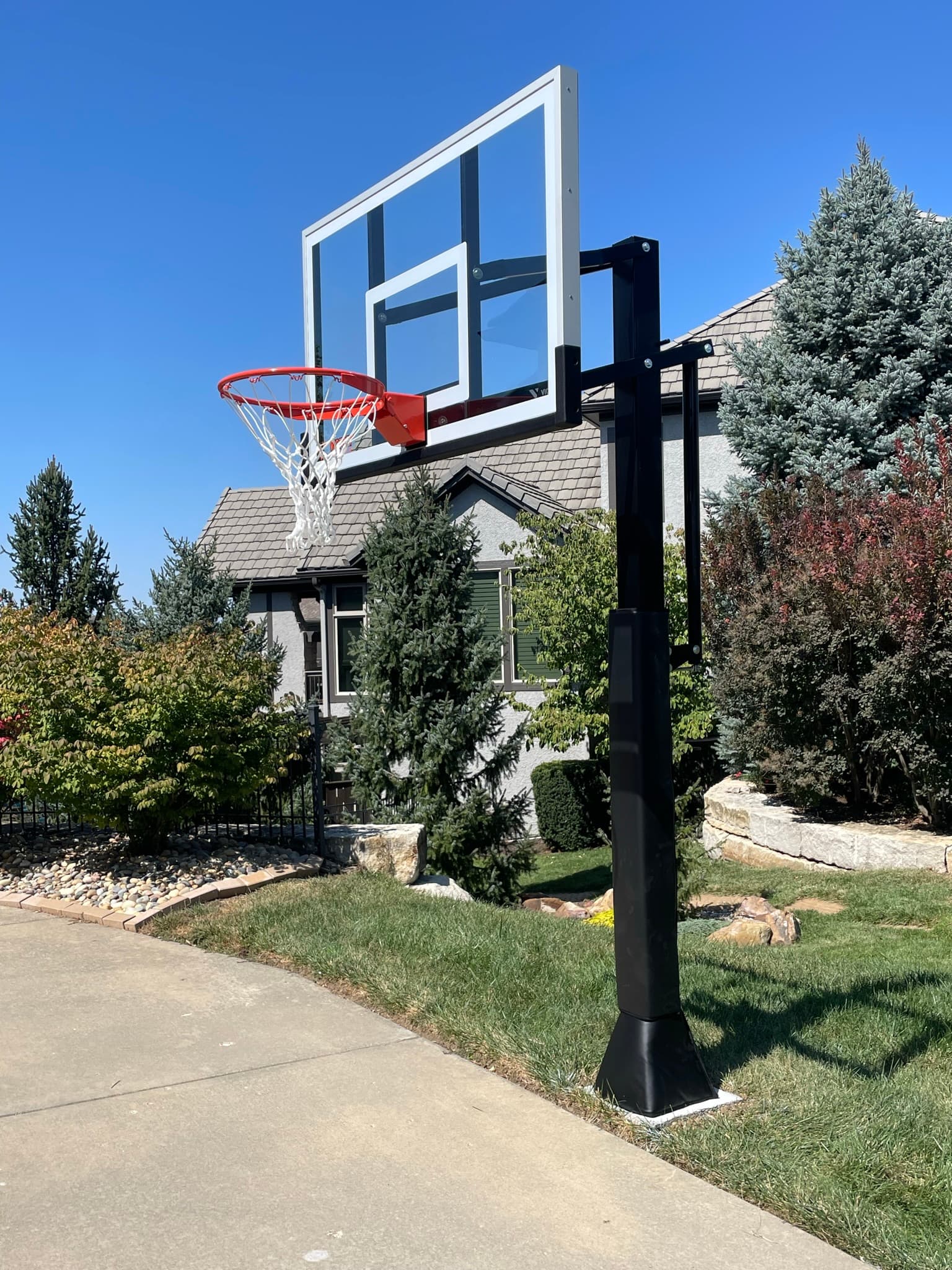 In ground basketball hoop on driveway
